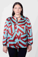 Mayes NYC Rosen Tie Neck Ruched Shoulder Blouse in Blue and Red Circle Stripes worn by model Megan Smith