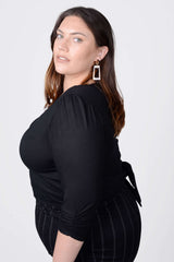 Mayes NYC Tamara Keyhole Wrap Top In Black worn by model Megan Smith